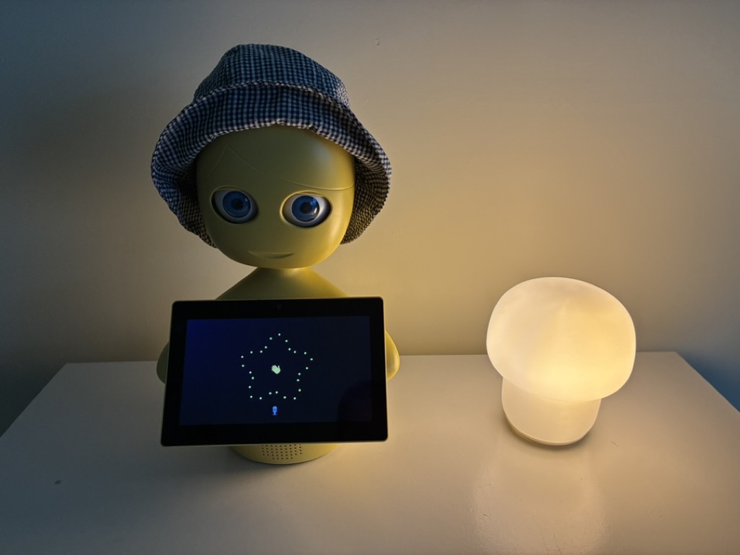 Mabu the robot on a tabletop with her lamp, now with a UI that allows talking to the chatbot